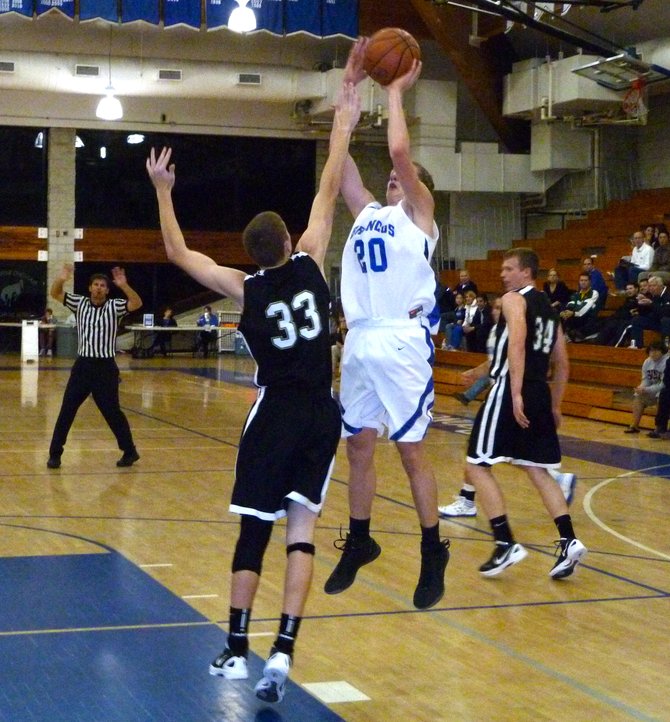 Rancho Bernardo forward Stephen Marrone puts up a jump shot over outstretched Westview forward Andrew McWilliam