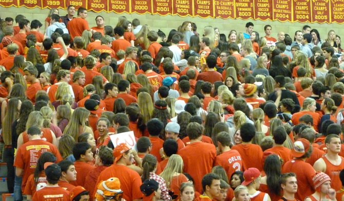Cathedral Catholic's student section turns its backs to the court as St. Augustine's starters are announced