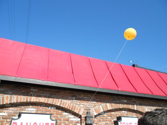 Birthday celebration balloon flying above Cafe La Maze in National City.