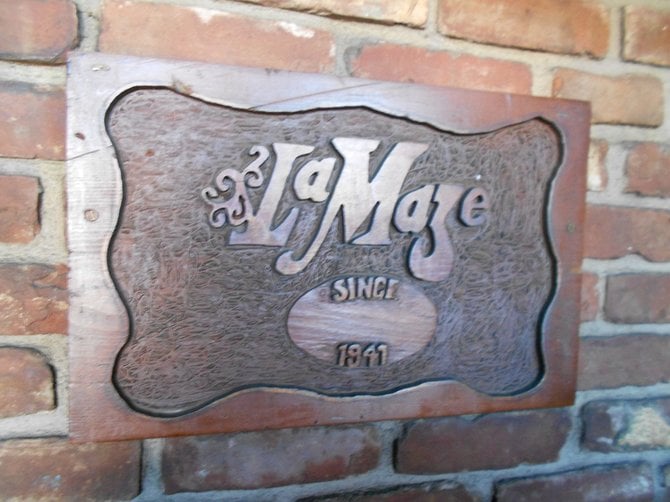 Eatery sign amid brickwork.