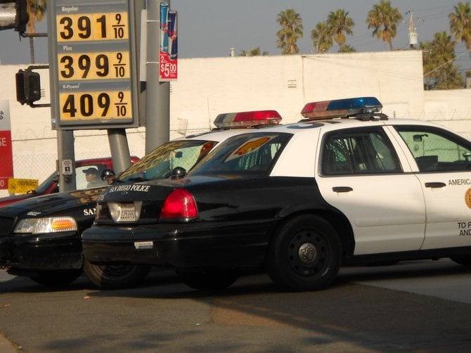 Cops mass at corner of Voltaire and Sunset Cliffs Blvd. Shell station.