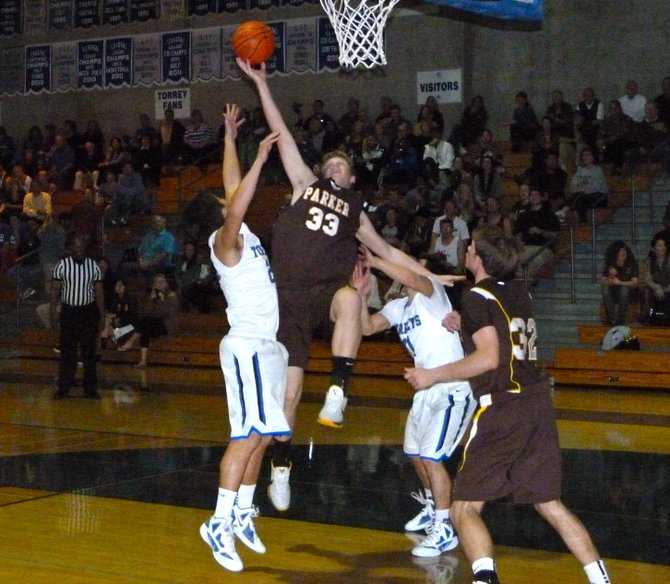 Francis Parker center Bryce Fitzner puts up a one-handed shot between two La Jolla Country Day defenders