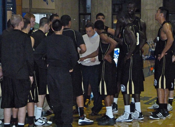 Army-Navy players huddle around head coach Tom Tarantino during a timeout