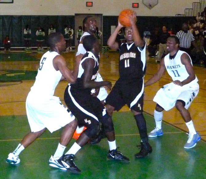 Mission Bay guard Jerald Albritton goes up for a shot between three Lincoln defenders