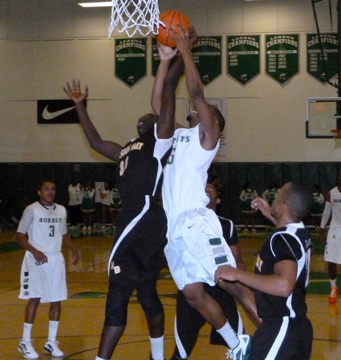Mission Bay guard Vince Petties-Wilson fights for a rebound in midair with Lincoln guard Steve Martin