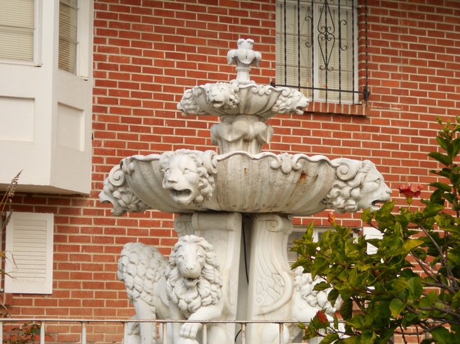 Beautifully ornate water fountain amid bricks in Point Loma front yard.