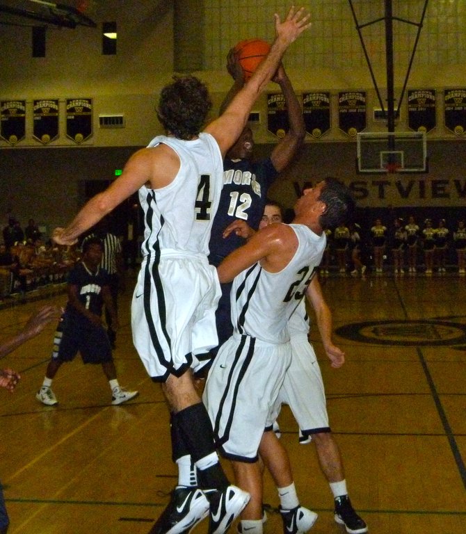 Morse guard Jah'mere Mitchell elevates to the basket between Westview guard Blake Watkins (4) and forward Cody Williams