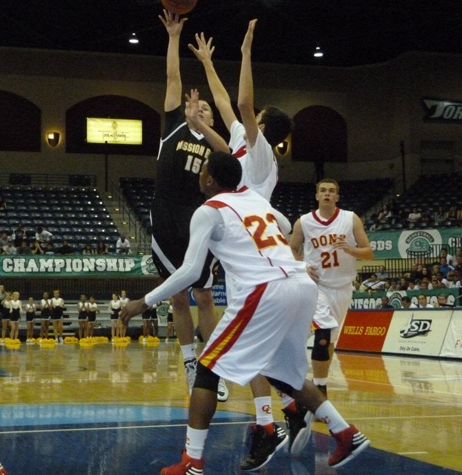  Mission Bay guard Dylan Holler floats a shot over two Cathedral Catholic defenders in the paint