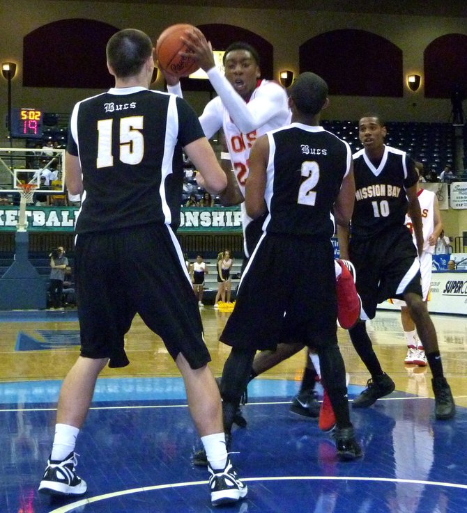 Cathedral Catholic forward Xavier Williams drives to the basket between three Mission Bay defenders