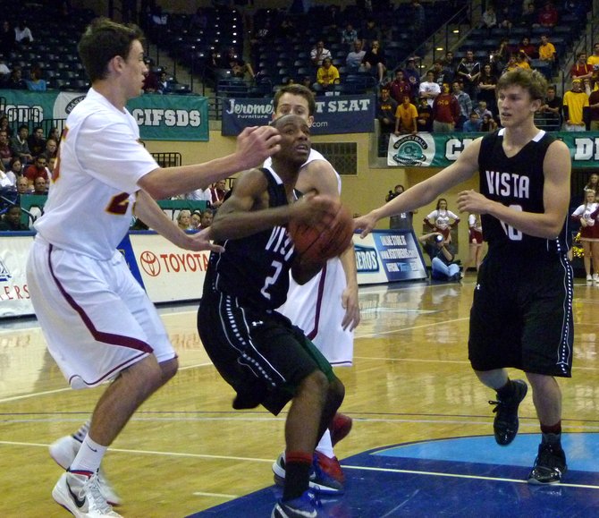 Vista guard John Fletcher drives to the basket in a crowded lane