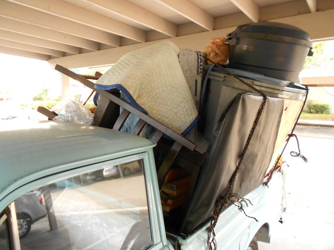 Car full of crap being stored illegally at Mariner's Cove apartments.