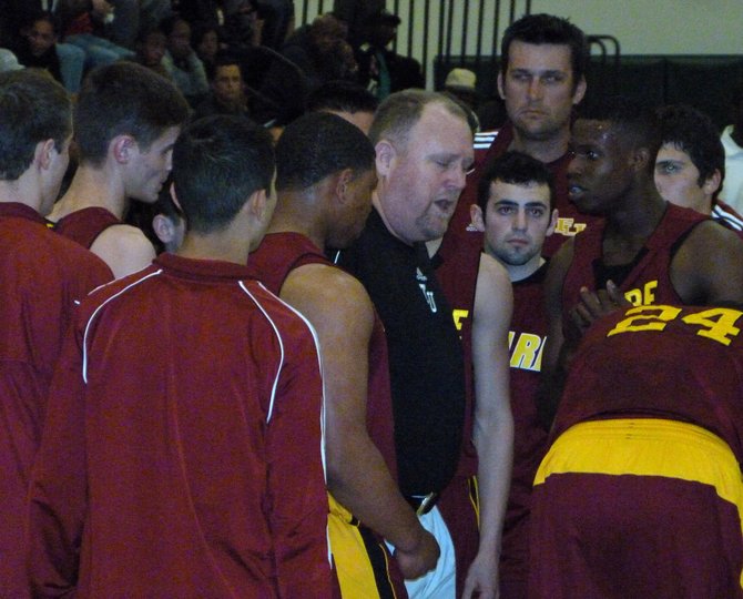 Tulare Union huddles up around coach Mark Hatton during a timeout