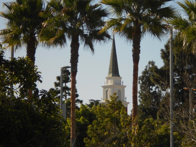 Red Brick Church steeple in Point Loma framed by trees.