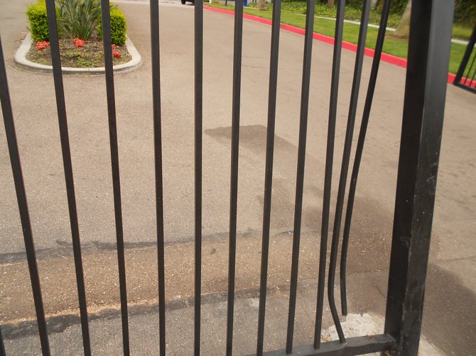 Broken gate rammed by resident at "gated community" of Mariner's Cove Apartments.