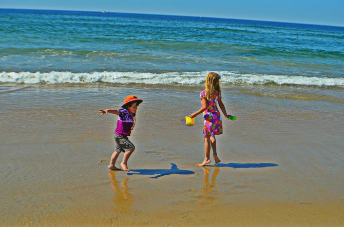 My kids running from the surf at Mission Beach