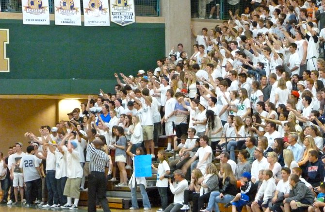 La Costa Canyon's white-clad student section holds up its hands during a Mavericks free throw attempt