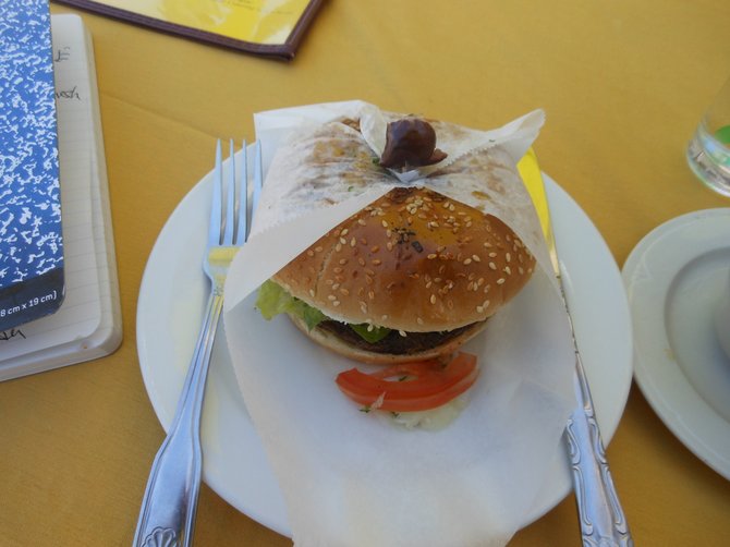 Burger comes with a bonnet, and a kalamata olive