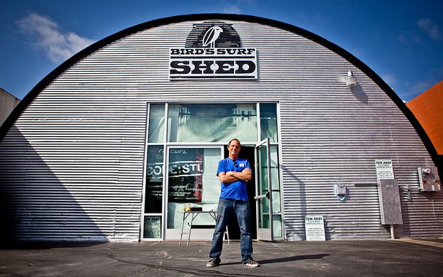 Eric "Bird" Huffman is the owner of Bird's Surf Shed in San Diego, a restored Quonset hut filled with his impressive collection of historically significant surfboards. (Photo Credit: Shawna Suffriti.)