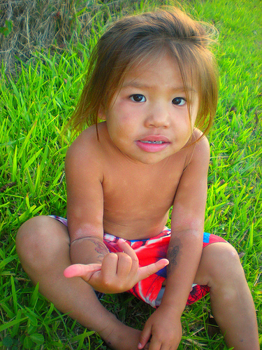 Hawaiian child giving shaka. 