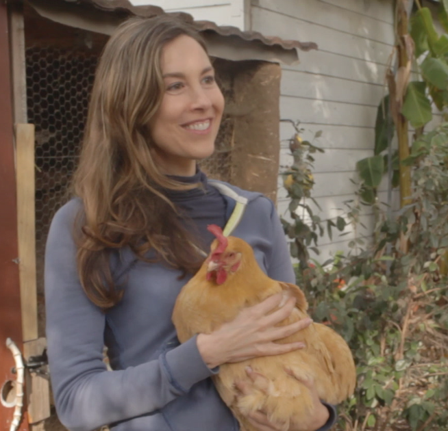 Rebecca Tolin holds a chicken for the first time.