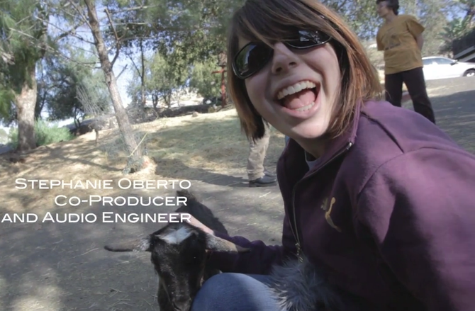 Stephanie quickly befriends baby goat.
