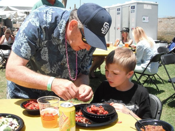 PopPop teaching his grandson how to get those crawdaddy heads at Gator By The Bay in the Reader's VIP section! 
