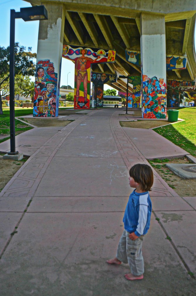 My son Fin, bedazzled by the murals at Chicano Park.