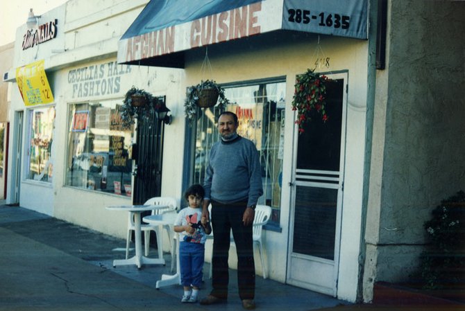 Zia Waleh with his daughter Somiyah outside his café in North Park around 1995. Zia recently returned to his homeland in northern Afghanistan.