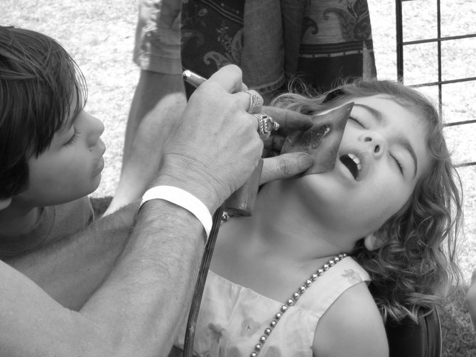A young girl gets her face painted in Mission Bay.