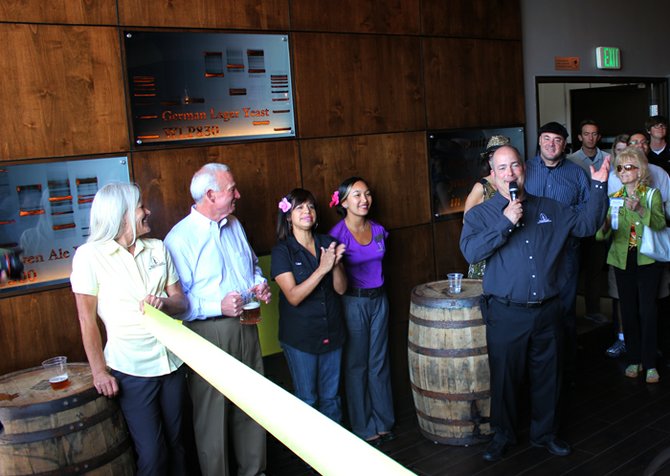 White Labs owner Chris White addresses the crowd at the grand opening of the company's tasting room on June 15