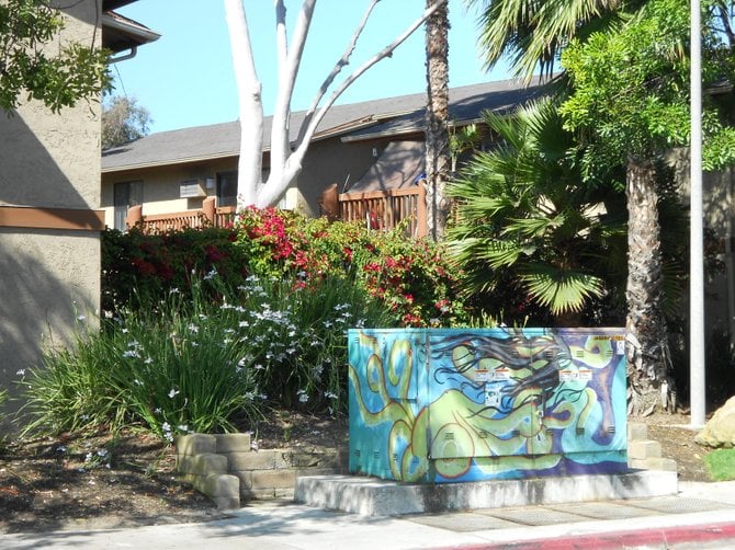 Colorful utility box art in front of Stonewood Apartments on Midway Dr.