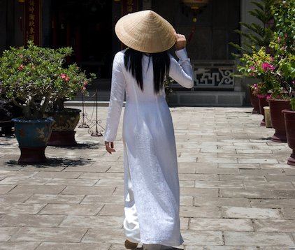 Outside a temple in Saigon (Ho Chi Minh City, officially): the classic white ao dai. 
