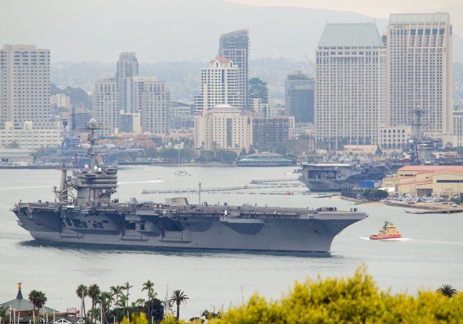 The aircraft carrier Stennis leaves San Diego bay on July 5, with carriers Carl Vinson and Midway in the background.  