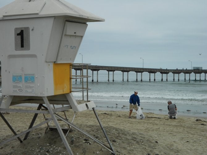 Clean-up volunteers help rid Ocean Beach of marshmallows at the Day After Clean-up.