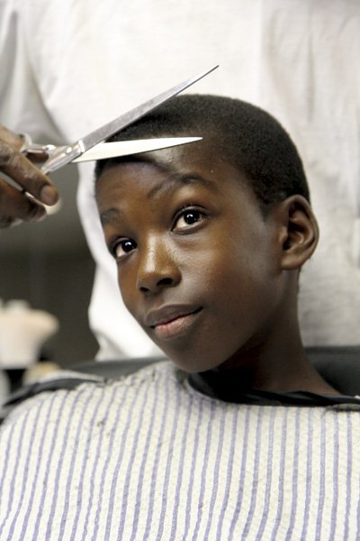 Ten-year-old Matthew Thomas gets his precision haircut at Milton’s barbershop in North Park.