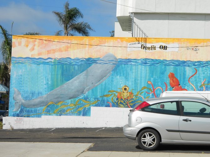 Whale art along wall on Narragansett Ave. in Ocean Beach.