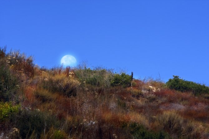 The moon setting over Lake Hodges in Escondido