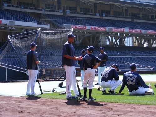 Will Venable explains some of the finer points of baseball to a youngster during Padres batting practice.