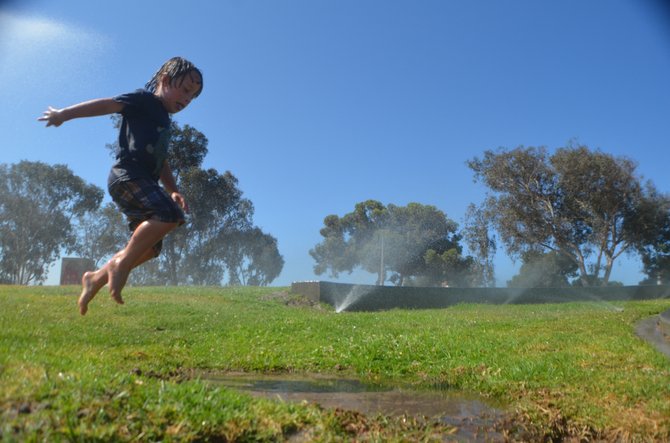 Puddle jumping at Mission Bay Playground, when the sprinklers were on