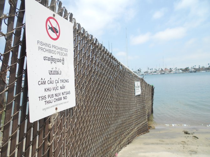 Fence with sign along San Diego Bay,