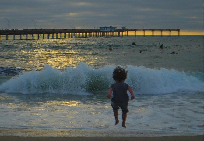 My son Fin jumping for joy. Ocean Beach.