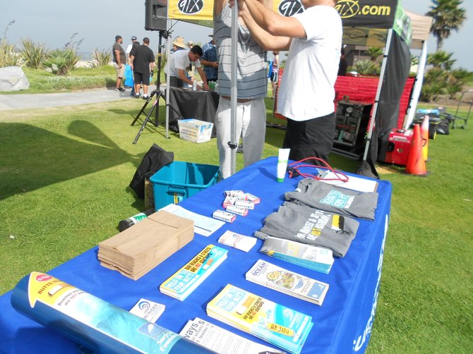 Setting up Surfrider info table at South Mission Beach beach clean-up.