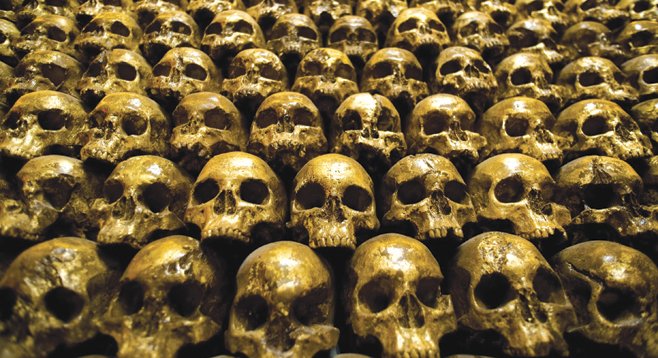 Enjoy a fine bourbon next to a wall of shimmering gold skulls at Noble Experiment.