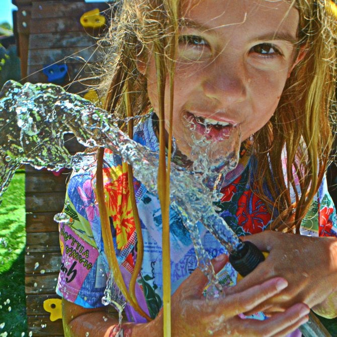 Drink from the Hose. My daughter Aidan in our backyard. Redwood Village.