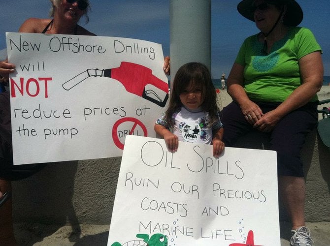 Politicking with my oil drilling sign at Hands Across the Sand.