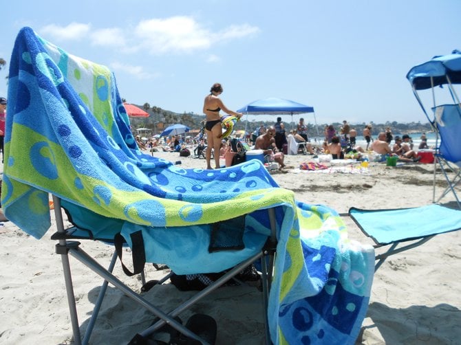 The good life and a comfy chair at crowded La Jolla Shores beach.