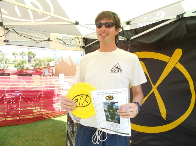 Winner posing with movie passes he won at South Mission Beach clean-up event.