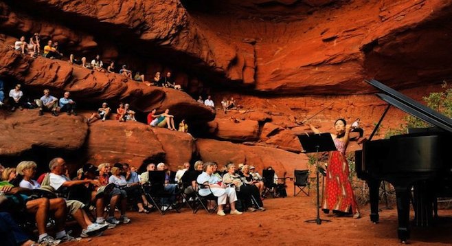 Great acoustics: the festival's Grotto Concerts are held in a natural red stone cave with high, arching ceilings. (photo by Richard Bowditch, reused with permission of moabmusicfest.org)