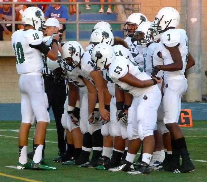 Helix junior quarterback Josh Harris calls out a play in the Highlanders huddle