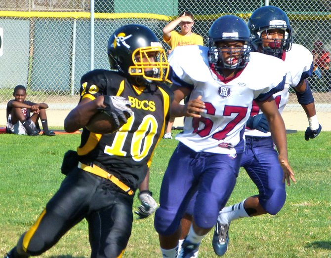 Mission Bay junior receiver Andre Petties-Wilson turns upfield in front of Horizon sophomore lineman Larry Miller on a kickoff return